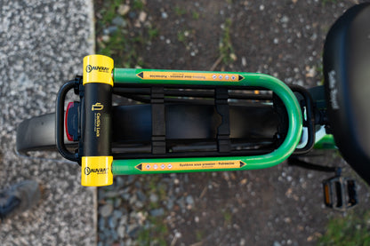 Vue de dessus de l’antivol Le Pionnier de CactUs Lock installé sur le porte-bagages d’un vélo avec signalétique de dissuasion visible.